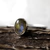 Spellbinding smal oval Sterling Silver Labradorite ring in blue and green colours on white background