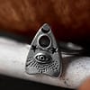 Recycled sterling silver ring with Ouija Spirit board detailed symbol, the ring sits on the edge of a light ceramic plate that holds a pumpkin