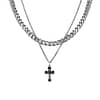 A cross pendant hanging in a thin chain in stainless steel combined with a large chunky chain on a white background