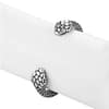 Two headed snake cuff bracelet with intricate details on a grey display stand for bracelets.