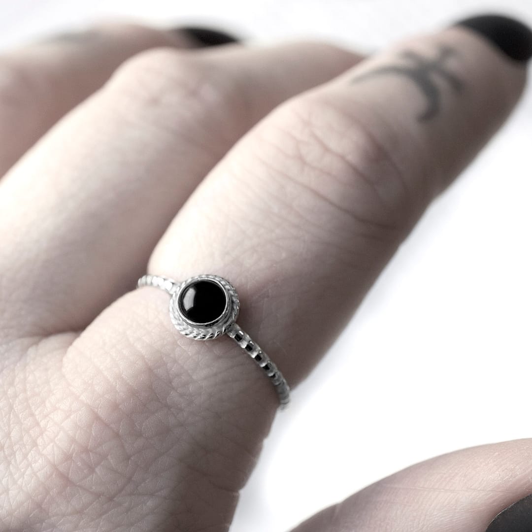 Round petite black Onyx Stacking Ring in lightweight sterling silver on finger with occult finger tattoos and black nails