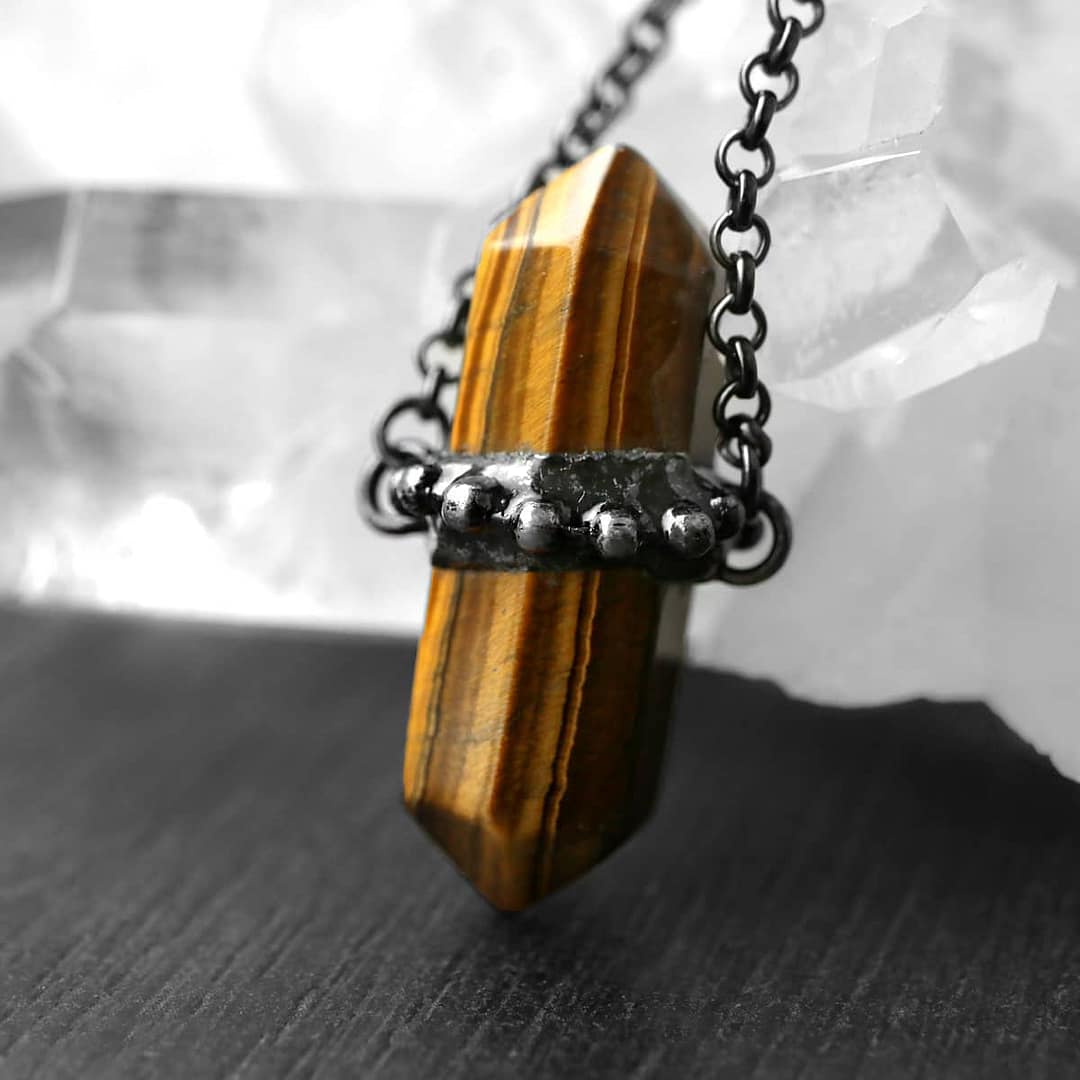 zaria-tiger-eye-necklace-hellaholics Close up photo of a beautiful brown tiger eye stone with natural stripes.