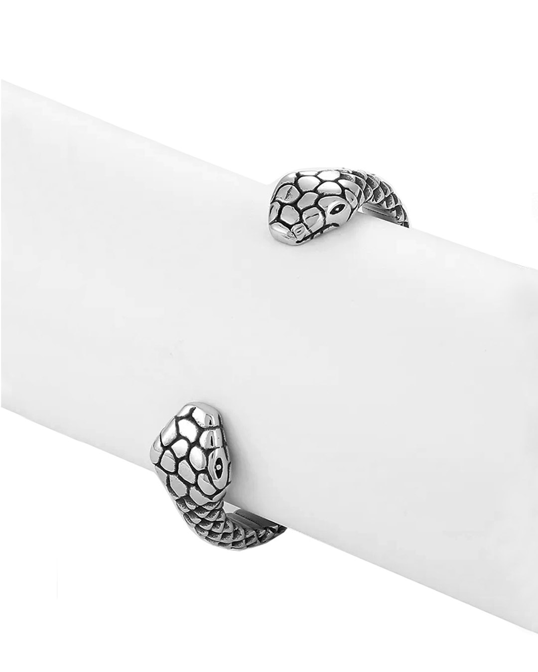 Two headed snake cuff bracelet with intricate details on a grey display stand for bracelets.