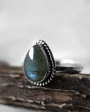 Spellbinding teardrop shaped Sterling Silver Labradorite ring in blue and green colours on white background