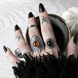Amber Shield Viking Ring - large amber silver ring paird with black onyx silver rings holding a cup of coffee, autum vibes