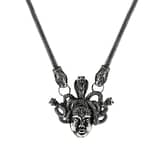 An antique silver-colored necklace with the symbol "Medusa".