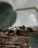 meadow leaf sterling silver ring on brown branch with green leafs