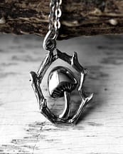 Close-up view of a recycled sterling silver necklace with intricate details and oxidised finish, the necklace is a mushroom enframed in branches, light nature themed background