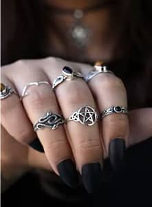 hand with a pentagram ring silver and duo snake ring silver, parid with tiger eye stone rings and rings with black onyx