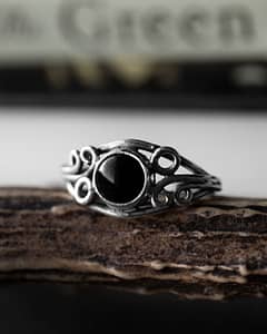 Arvani sterling silver adjustable ring with black onyx stone on a brown branch