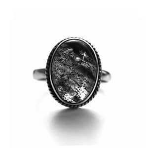 oval rutilated quartz ring in sterling silver on white background