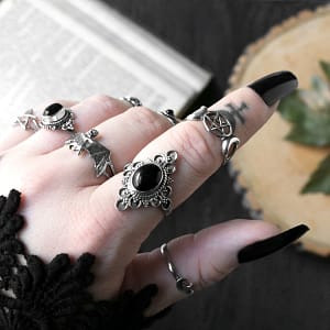 Close-up Ariana black stone ring, paired with witchy rings, one pentagram och one bat ring, all in 925 sterling silver