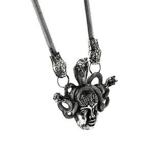 An antique silver-colored statement necklace with the symbol "Medusa".
