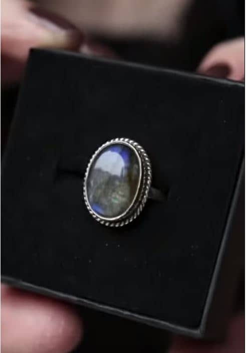oval silver labradorite ring on black background