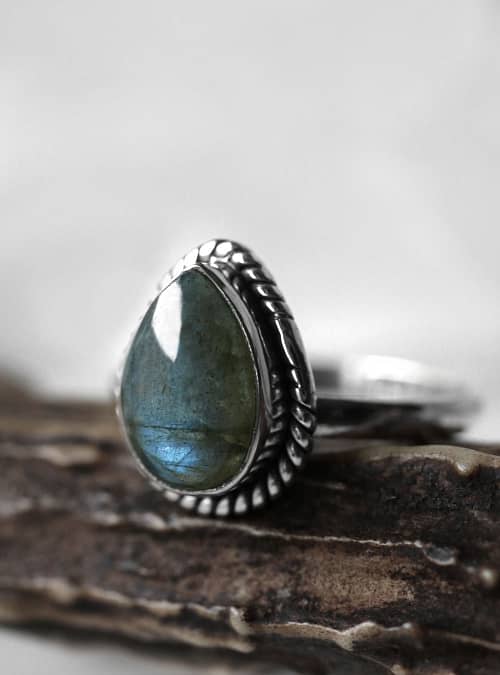 Spellbinding teardrop shaped Sterling Silver Labradorite ring in blue and green colours on white background