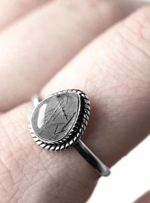 drop-shaped rutilated quartz ring in sterling silver, close up photo on finger