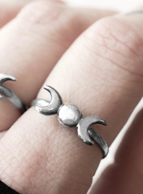 triple moon sterling silver ring on a finger