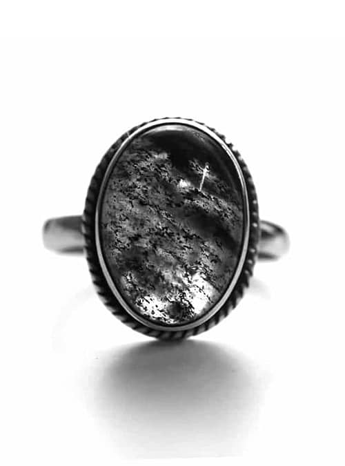 oval rutilated quartz ring in sterling silver on white background