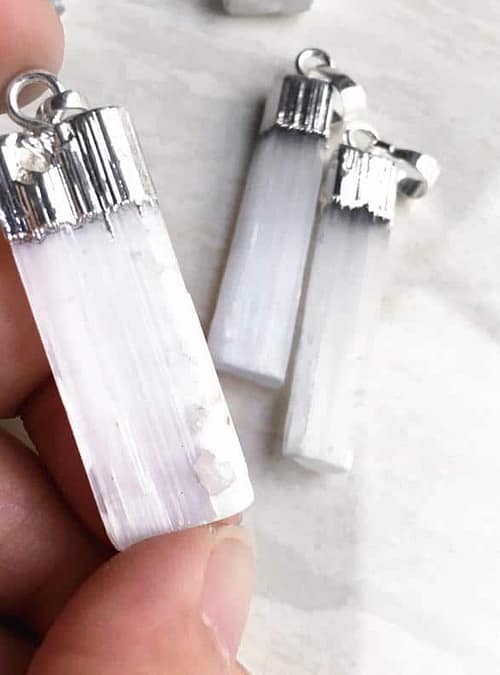 silver-selenite-necklace-hellaholics-hand