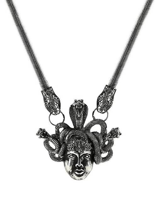 An antique silver-colored necklace with the symbol "Medusa".