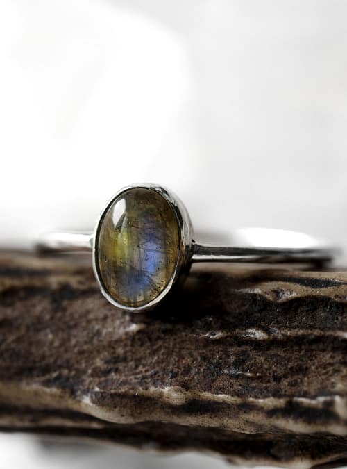 Spellbinding smal oval Sterling Silver Labradorite ring in blue and green colours on white background