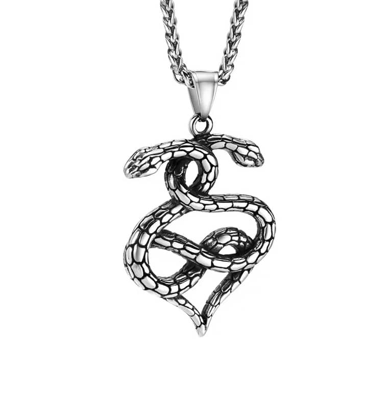 A pendant with two snakes entwined in a heart shape. Hanging in a stainless steel chain on a white background.
