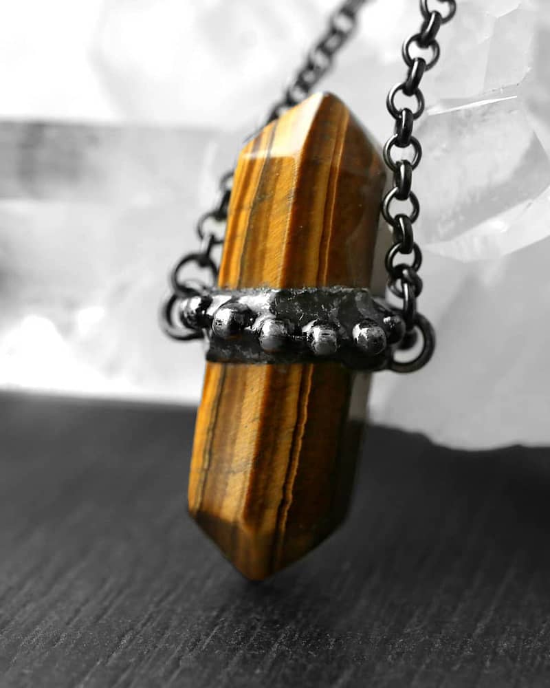 Close up photo of a beautiful brown tiger eye stone with natural stripes.