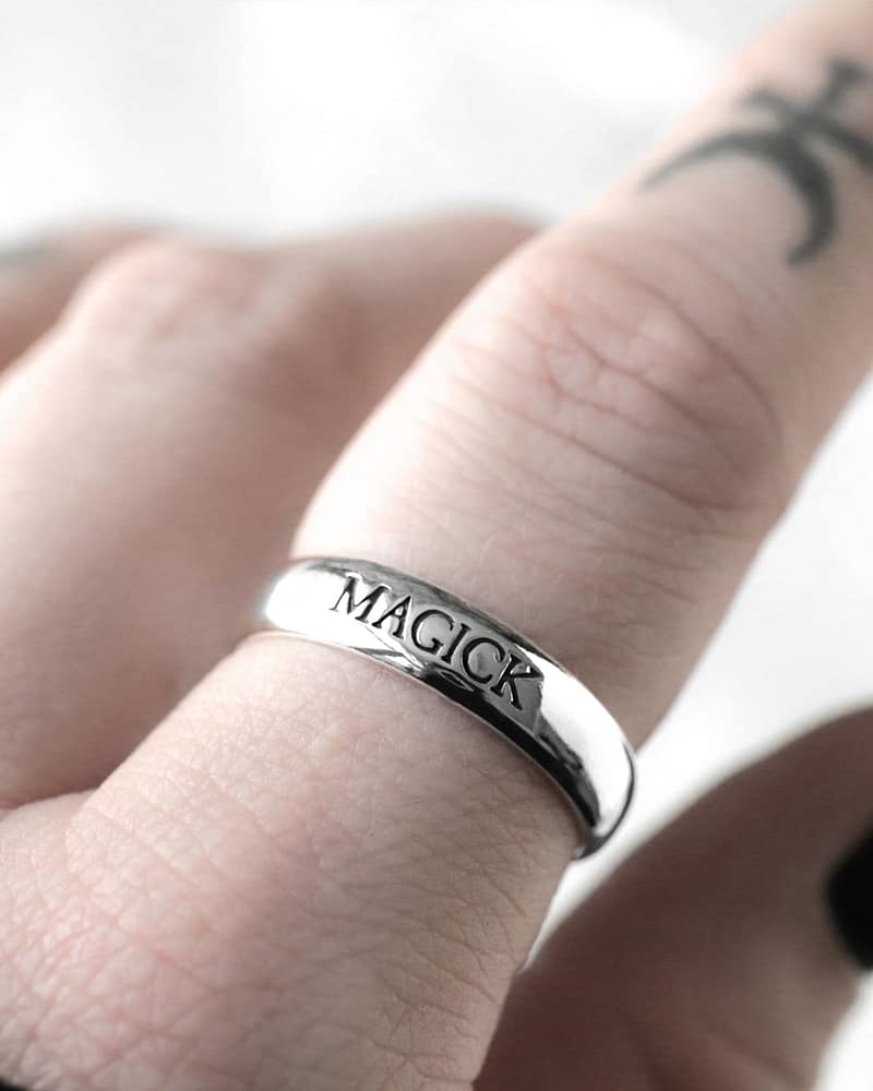 Sterling silver ring with the text "magick"