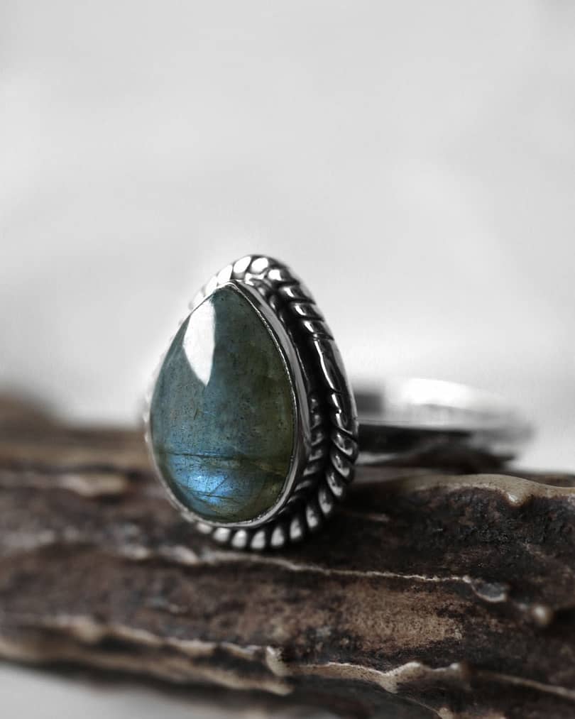 Spellbinding teardrop shaped Sterling Silver Labradorite ring in blue and green colours on white background