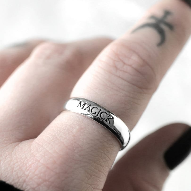 Sterling silver ring with the text "magick"