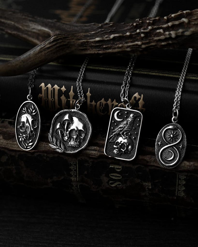 occult sterling silver necklaces in gothic style. 1 bird skull necklace, 1 memento more skull necklace, 1 raven necklace and 1 serpent snake necklace